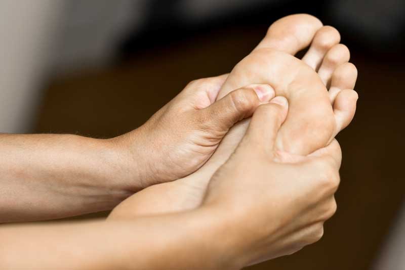 Practitioner applying acupressure to points on the sole of a foot