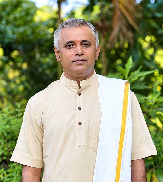 Srividya teacher in a cream kurta and white angavastram with a gold border